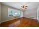 Bright living room featuring hardwood floors, a ceiling fan, and large windows at 87 Virgil Sw St, Mableton, GA 30126