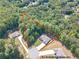 Aerial view of the home showcasing the expansive, tree-lined lot in a quiet neighborhood at 150 Whitworth Dr, Locust Grove, GA 30248