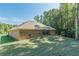 Brick home in a private wooded lot, with views of the landscaped backyard at 150 Whitworth Dr, Locust Grove, GA 30248