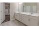 Bathroom featuring dual sink vanity, tile flooring, and access to a walk-in closet at 150 Whitworth Dr, Locust Grove, GA 30248