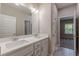 Bathroom with double sink vanity, large mirror and access to bedroom in neutral colors at 150 Whitworth Dr, Locust Grove, GA 30248