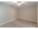 Bedroom with ceiling fan, neutral paint, and neutral patterned carpeting at 150 Whitworth Dr, Locust Grove, GA 30248