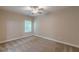 A cozy bedroom with soft carpet, a ceiling fan and light from the window creates a relaxing atmosphere at 150 Whitworth Dr, Locust Grove, GA 30248