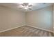 Neutral bedroom featuring gray carpet, a ceiling fan, and a bright window at 150 Whitworth Dr, Locust Grove, GA 30248