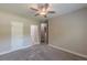 A well lit bedroom with neutral colors and access to bathroom and walk-in closet at 150 Whitworth Dr, Locust Grove, GA 30248