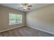 A well lit bedroom with neutral colors and a window at 150 Whitworth Dr, Locust Grove, GA 30248