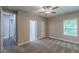 A well lit bedroom with neutral colors, ceiling fan, access to bathroom and walk-in closet at 150 Whitworth Dr, Locust Grove, GA 30248