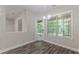 Light-filled dining room with hardwood floors has backyard access and a view to the next room at 150 Whitworth Dr, Locust Grove, GA 30248