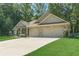 Well-maintained single-story home with a spacious driveway and manicured front yard offers great curb appeal at 150 Whitworth Dr, Locust Grove, GA 30248