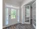 Welcoming foyer with hardwood floors, showcasing a front door with sidelights and glass French doors at 150 Whitworth Dr, Locust Grove, GA 30248