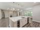 Open kitchen with center island, quartz countertops and stainless steel appliances at 150 Whitworth Dr, Locust Grove, GA 30248