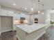 The kitchen features white cabinets, stainless steel appliances, a center island and pendant lighting at 150 Whitworth Dr, Locust Grove, GA 30248