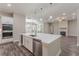 Modern kitchen features stainless steel appliances, central island and quartz countertops at 150 Whitworth Dr, Locust Grove, GA 30248