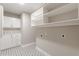 Functional laundry room features cabinets, drawers, and unique patterned tile flooring at 150 Whitworth Dr, Locust Grove, GA 30248