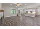 Open concept living room featuring hardwood floors, modern fireplace and access to kitchen at 150 Whitworth Dr, Locust Grove, GA 30248