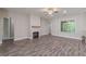 Bright living room featuring hardwood floors, a fireplace, and large windows at 150 Whitworth Dr, Locust Grove, GA 30248