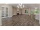Open-concept living area featuring hardwood floors, a fireplace, and French doors to adjacent rooms at 150 Whitworth Dr, Locust Grove, GA 30248