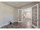 Open-concept living space with hardwood floors and French doors, offering a glimpse into the adjacent kitchen at 150 Whitworth Dr, Locust Grove, GA 30248
