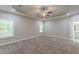 Spacious main bedroom with tray ceiling, ceiling fan and carpeted floors at 150 Whitworth Dr, Locust Grove, GA 30248