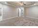 Large main bedroom boasts carpeted floors, neutral paint and tray ceilings at 150 Whitworth Dr, Locust Grove, GA 30248