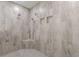 Modern shower with gray stone look tile and two shower heads at 150 Whitworth Dr, Locust Grove, GA 30248