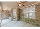 Covered sunroom with brick walls, ceiling fan, windows and door leading to the backyard at 150 Whitworth Dr, Locust Grove, GA 30248