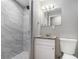 Updated bathroom with marble-tiled shower, granite vanity, and contemporary fixtures for a modern look at 1879 Rosewood Rd, Decatur, GA 30032