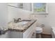 Bathroom featuring granite countertop, white cabinetry, and a tiled backsplash at 1879 Rosewood Rd, Decatur, GA 30032