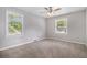Bedroom featuring neutral walls, plush carpeting, and natural light streaming through the windows at 1879 Rosewood Rd, Decatur, GA 30032