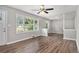 Bright and airy living room with hardwood floors, large windows, neutral paint, and modern ceiling fan at 1879 Rosewood Rd, Decatur, GA 30032