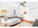 Bright bedroom features hardwood floors, a ceiling fan, and a charming world map accent wall at 228 Olympic Pl # 47, Decatur, GA 30030