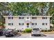 Well-maintained two-story apartment building exterior with ample parking, landscaping, and manicured lawn at 228 Olympic Pl # 47, Decatur, GA 30030