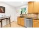 Well-lit kitchen with granite counters, stainless steel dishwasher, wood cabinets, tile floors, and an adjacent dining space at 228 Olympic Pl # 47, Decatur, GA 30030