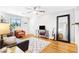 Bright living room with hardwood floors, modern decor, ceiling fan, and large mirror creates a welcoming and stylish space at 228 Olympic Pl # 47, Decatur, GA 30030