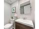 Stylish powder room featuring a modern vanity with a white countertop and an updated mirror at 27 Jefferson Hill Ne Pl, Atlanta, GA 30342