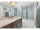 Bright bathroom with a glass shower/tub combo, granite countertop, decorative tiles and sea-themed decor at 27 Jefferson Hill Ne Pl, Atlanta, GA 30342