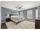 Comfortable bedroom with a ceiling fan, a cozy rug, and natural light coming through plantation shutters at 27 Jefferson Hill Ne Pl, Atlanta, GA 30342