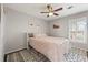 Bedroom with a ceiling fan, an area rug and a bed with a headboard bookcase and decorative art at 27 Jefferson Hill Ne Pl, Atlanta, GA 30342