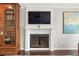 Elegant fireplace with white mantel, display niche, and dark screen against a light gray wall at 27 Jefferson Hill Ne Pl, Atlanta, GA 30342