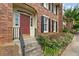 Inviting front entrance with a red door framed by sidelights and concrete steps with metal railings at 27 Jefferson Hill Ne Pl, Atlanta, GA 30342