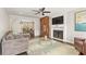 Cozy living room featuring a fireplace, ceiling fan, and comfortable seating with access to the dining room at 27 Jefferson Hill Ne Pl, Atlanta, GA 30342