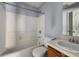 Bathroom featuring a tub and shower combination, light-blue walls and a wood vanity at 3949 Riverside Pkwy, Decatur, GA 30034