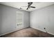 This cozy carpeted bedroom features a ceiling fan and a window for natural light at 3949 Riverside Pkwy, Decatur, GA 30034