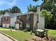 Brick and siding two-story house with a well-manicured lawn, chimney, and an attached garage at 3949 Riverside Pkwy, Decatur, GA 30034