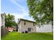 View of the house from the backyard with green grass, siding, and mature trees at 3949 Riverside Pkwy, Decatur, GA 30034