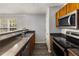 Functional kitchen with stainless steel appliances, dark countertops and wood cabinets at 3949 Riverside Pkwy, Decatur, GA 30034