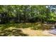 Large backyard featuring grassy area with mature trees at 8420 Sheridan Dr, Jonesboro, GA 30236
