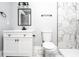 Updated bathroom featuring white marble walk-in shower, vanity, and black fixtures at 8420 Sheridan Dr, Jonesboro, GA 30236