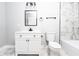 Elegant bathroom featuring marble-style tiling, a white vanity with a black faucet, and a toilet at 8420 Sheridan Dr, Jonesboro, GA 30236