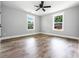 Bedroom featuring two windows, a ceiling fan, and hardwood floors at 8420 Sheridan Dr, Jonesboro, GA 30236